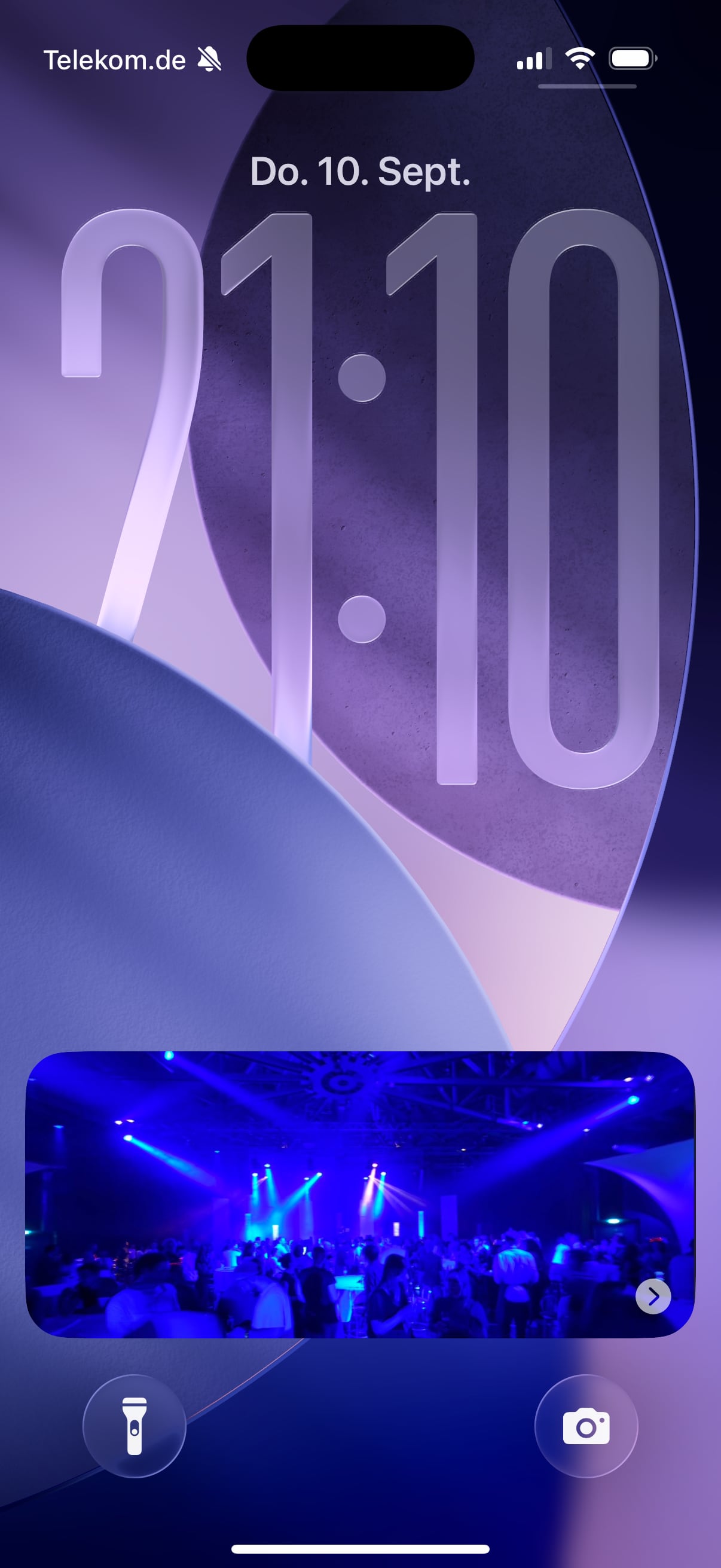 iPhone Lock Screen with a full-size photo in a Live Activity